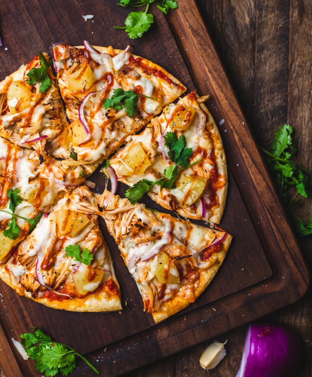 overhead of barbecue chicken pizza topped with pineapple