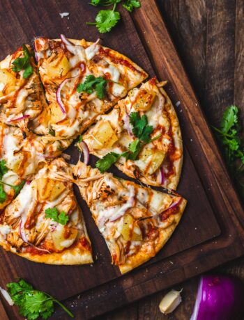 overhead of barbecue chicken pizza topped with pineapple