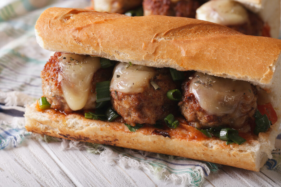 close-up side view of cheesy chicken meatball sub sandwich