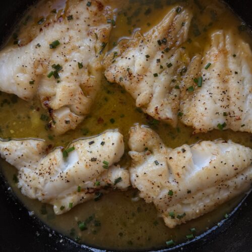 Close up photo of miso butter cod in cast iron skillet
