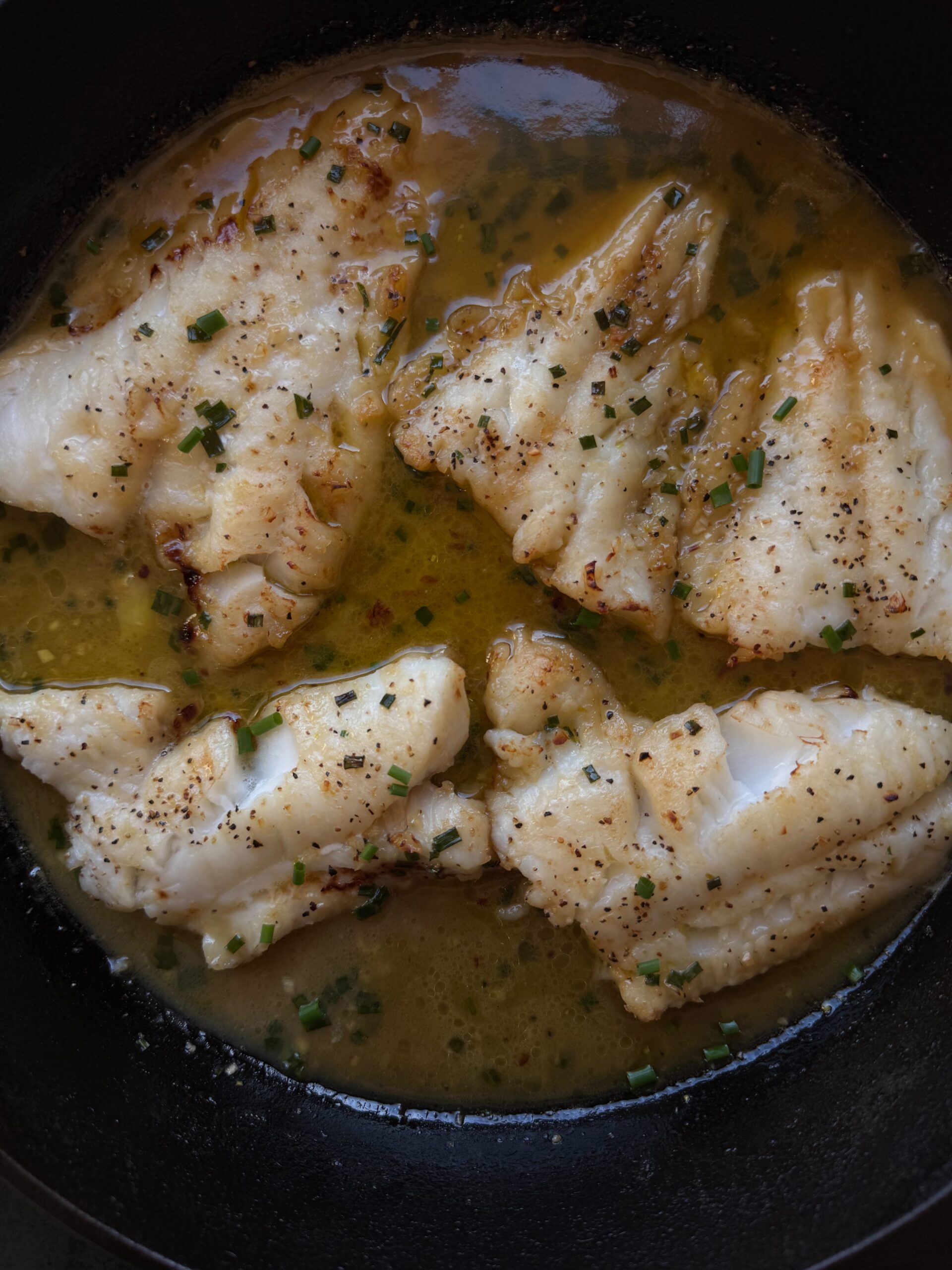 Close up photo of miso butter cod in cast iron skillet