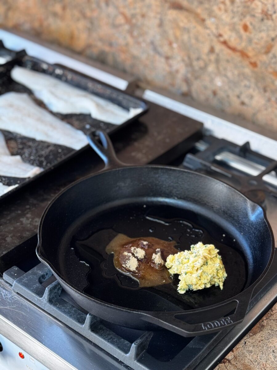 overview photo of miso butter ingredients in cast iron skillet with uncooked cod on rimmed baking sheet