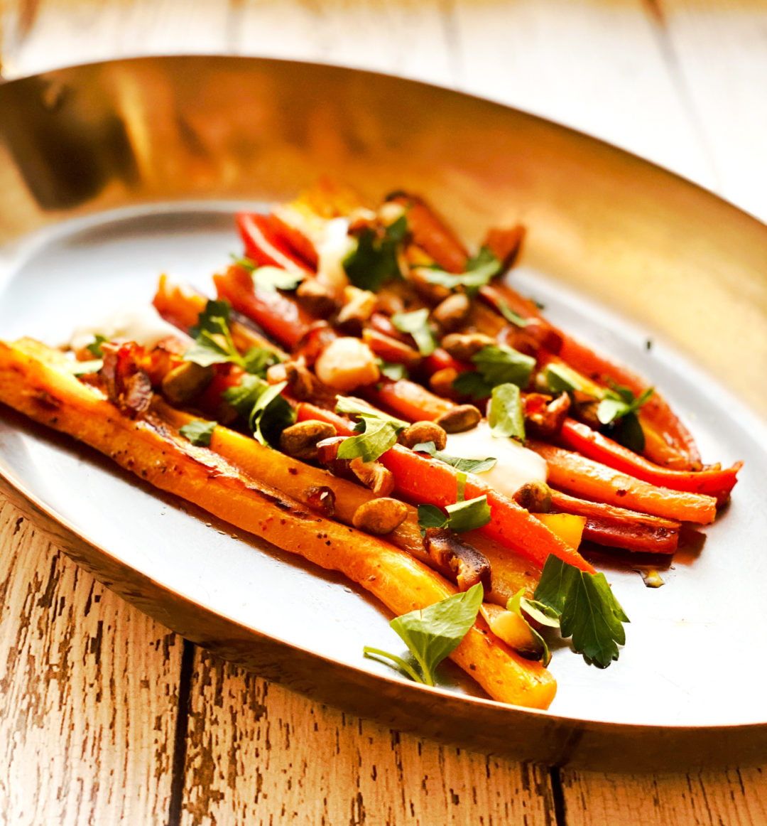 carrots on platter with fresh herbs