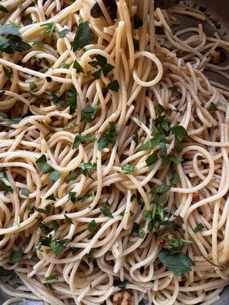 closeup of spaghetti with walnuts and anchovies