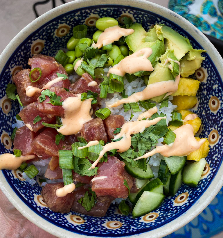 overhead of bowl with ahi tuna, avocado, cilantro and spicy mayo
