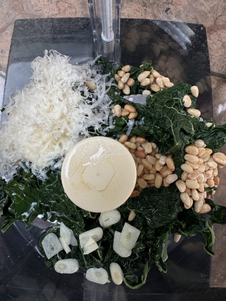 Overhead photo of kale pesto ingredients in food processor