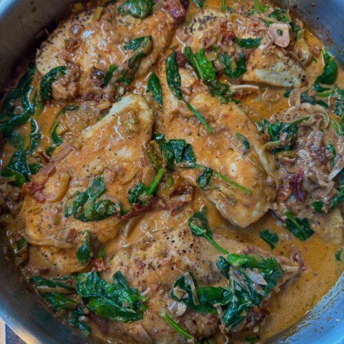 chicken in sundried tomato and spinach sauce in skillet
