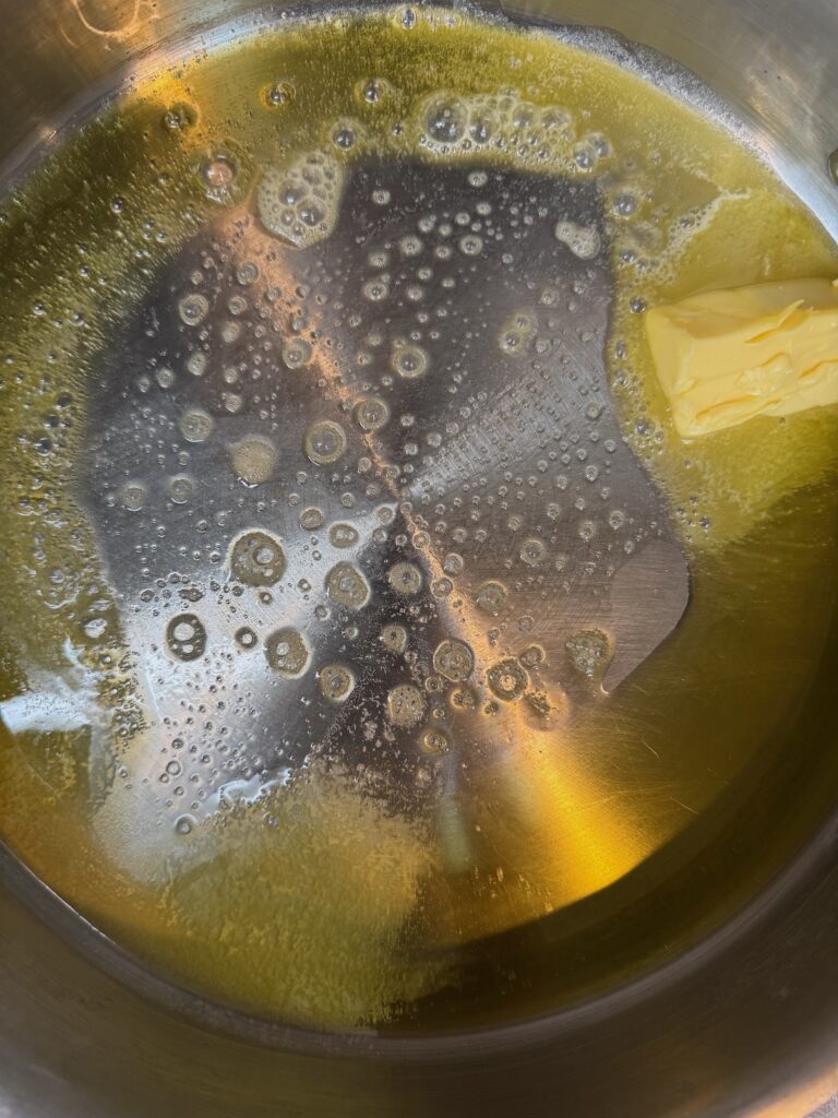 melted butter in a stainless steel pan
