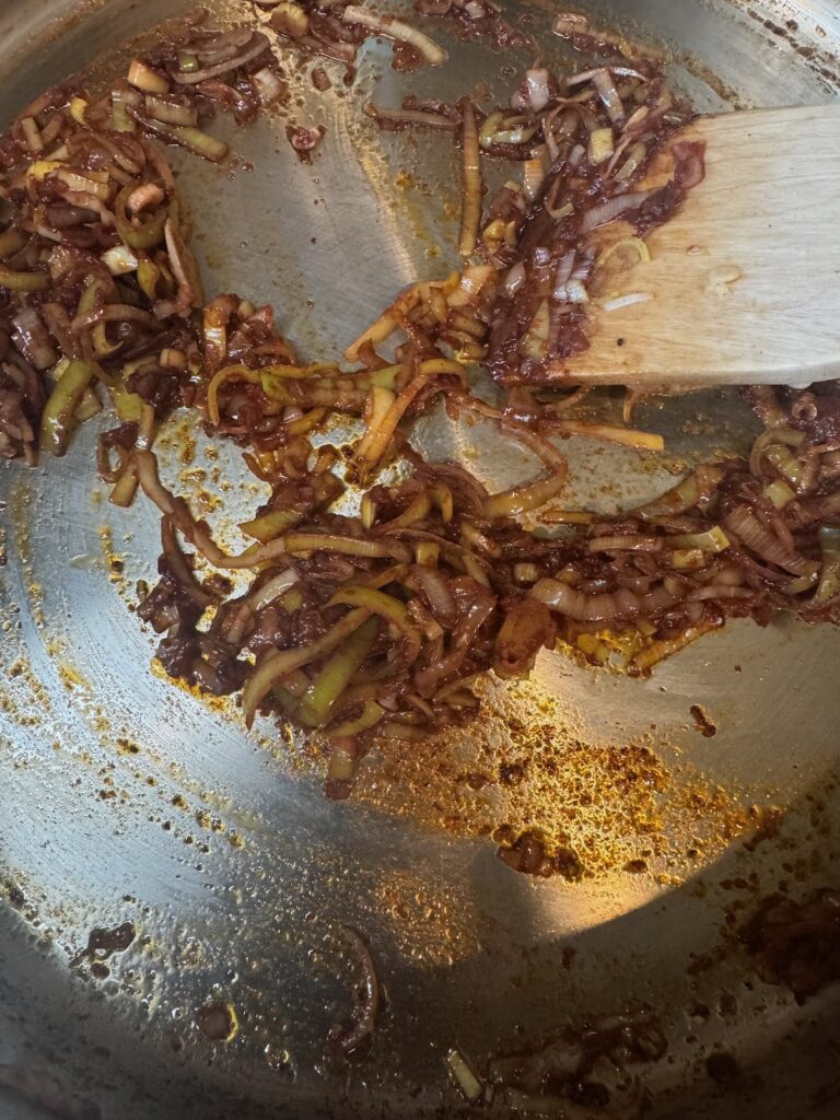 sautéed leeks with tomato paste in skillet