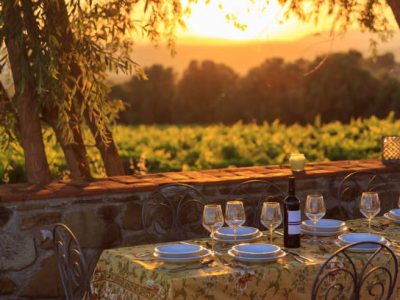 Outdoor table with vineyard background in susnet time in tuscany italy